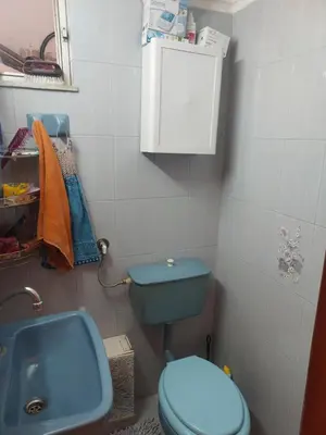 a bathroom with a blue toilet and a sink at Villa Nancy in Chania Town