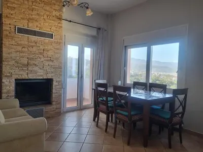 a dining room with a table and chairs and a fireplace at Villa Nancy in Chania Town