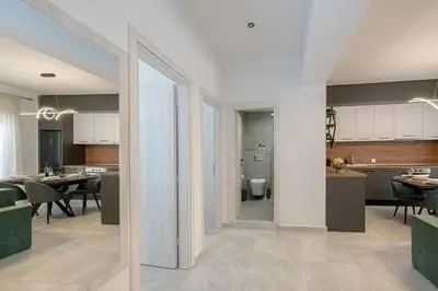 a kitchen and living room with a dining room at Luxury Chic Retreat Suites in Chania Town