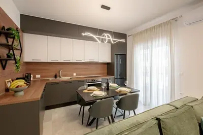 a kitchen and dining room with a table and chairs at Luxury Chic Retreat Suites in Chania Town