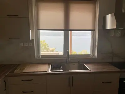 a kitchen with a sink and a window at Moments in Áptera