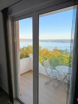 a sliding glass door with a view of the ocean at Moments in Áptera