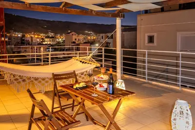 a patio with a table and chairs on a balcony at Sea Stars Cozy Suite in Souda