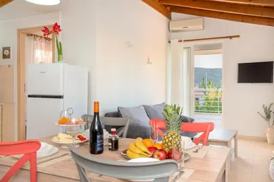 a living room with a table with fruit on it at Sea Stars Cozy Suite in Souda