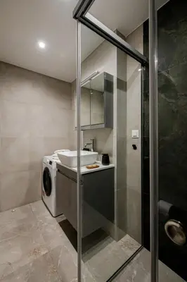 a bathroom with a washing machine and a sink at Boho Chic Retreat Suite in Chania Town