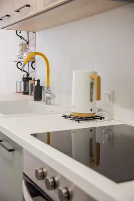 a kitchen with a sink and a sewing machine on a counter at Minimal Chic Retreat Suite in Chania Town