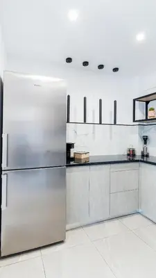 a stainless steel refrigerator in a kitchen at Seascape Luxury Apartment in Kounoupidhianá