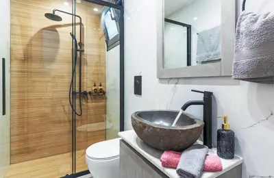 a bathroom with a bowl sink and a shower at Seascape Luxury Apartment in Kounoupidhianá