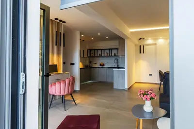 a kitchen and living room with a table and chairs at Seascape Luxury Apartment in Kounoupidhianá