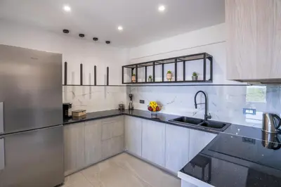 a kitchen with a stainless steel refrigerator and a sink at Seascape Luxury Apartment in Kounoupidhianá
