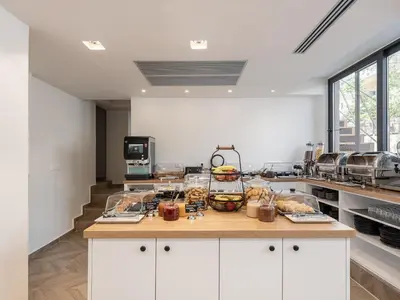 a kitchen with a counter with food on it at Miss Marrone City Hotel in Chania Town