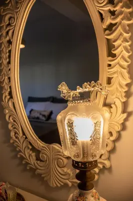 a white vase sitting in front of a mirror at Natalia's Apartment in Tavronitis in Tavronitis