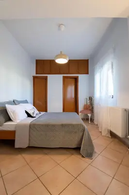 a bedroom with a large bed in a room at Natalia's Apartment in Tavronitis in Tavronitis