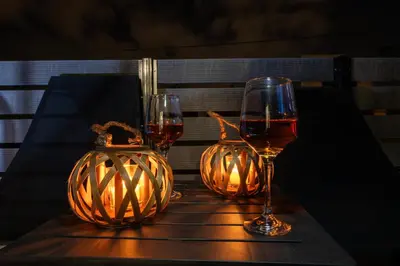 a table with two glasses of wine and a pumpkin at 7thHeaven Luxury aprts in Chania Town