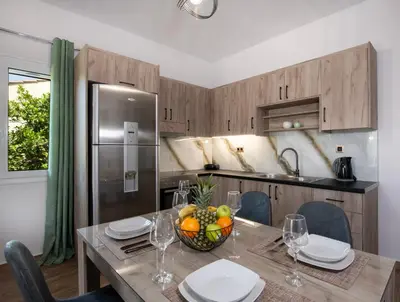 a kitchen with a table with a bowl of fruit on it at 7thHeaven Luxury aprts in Chania Town