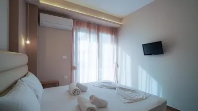 a hotel room with a bed with towels on it at Odyssey Residences 2 in Chania Town