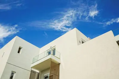 a white building with a sky in the background at Odyssey Residences 2 in Chania Town