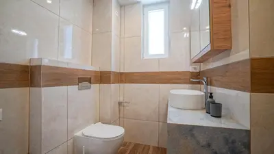 a bathroom with a toilet and a sink at Odyssey Residences 2 in Chania Town
