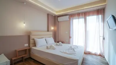 a bedroom with a bed with two towels on it at Odyssey Residences 2 in Chania Town