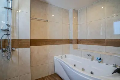 a bathroom with a tub and a shower at Odyssey Residences 2 in Chania Town