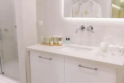 a white bathroom with a sink and a shower at Nobel apartment, Chania Town in Chania Town