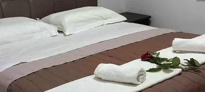a bed with towels and a rose on it at Emmanuel apartment in Agia Marina Nea Kydonias