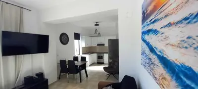 a living room with a kitchen and a dining room at Emmanuel apartment in Agia Marina Nea Kydonias