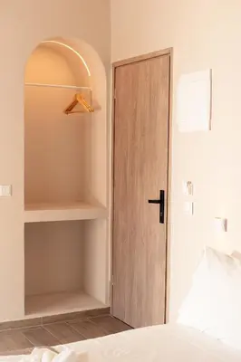 a bedroom with a closet with a wooden door at Serena in Chania Town