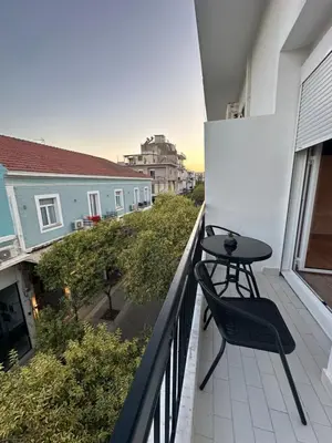 a balcony with a table and a chair on it at Serena in Chania Town