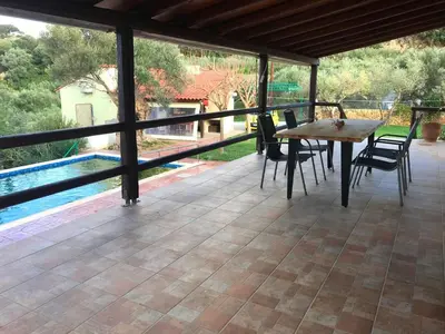 a patio with a table and chairs and a pool at Impressive Platanias Villa Villa Bulma 2 Bedrooms Private Pool in Plataniás