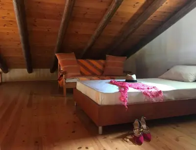 a bedroom with a bed and a couch in a attic at Impressive Platanias Villa Villa Bulma 2 Bedrooms Private Pool in Plataniás