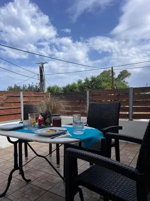 a table and two chairs on a patio at Karamela Apartment in Kambánion