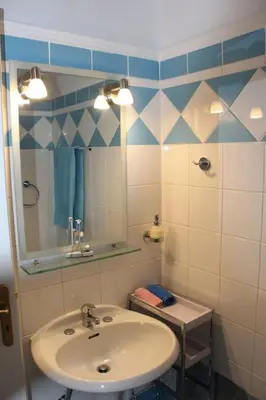 a bathroom with a sink and a mirror at The Blue Studio, 1 min walk from Kalamaki beach in Kalamaki Chanion