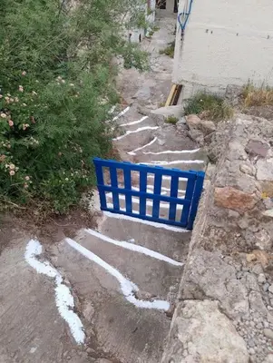 a blue chair sitting on the side of a road at Fortezza studio in Palaiochóra
