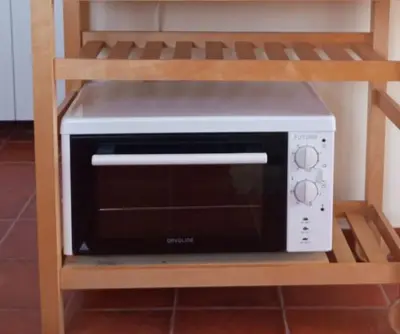 a microwave oven sitting on a shelf at Fortezza studio in Palaiochóra