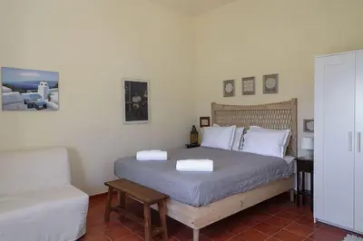 a bedroom with a bed with two towels on it at Fortezza studio in Palaiochóra