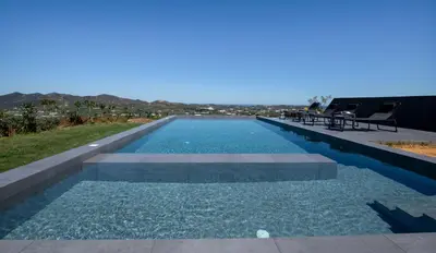 a swimming pool with chairs on the roof of a house at Arithea Villa in Chania Town
