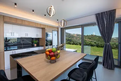a kitchen with a wooden table with a bowl of fruit at Arithea Villa in Chania Town