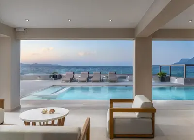a swimming pool with a view of the ocean at LUXURY VILLA EOS Beachfront 20 metres from the sea in Nopíyia
