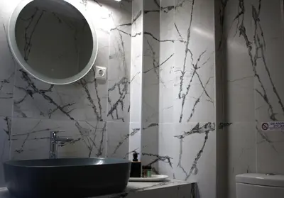 a bathroom with a sink and a mirror on the wall at Paliochora Beachfront Escape, Milolithos Pool Retreats in Palaiochóra