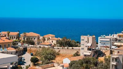 a view of a town with the ocean in the background at Mariam Luxury Apartments in Chania Town