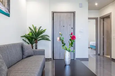 a living room with a couch and a table with flowers at Mariam Luxury Apartments in Chania Town