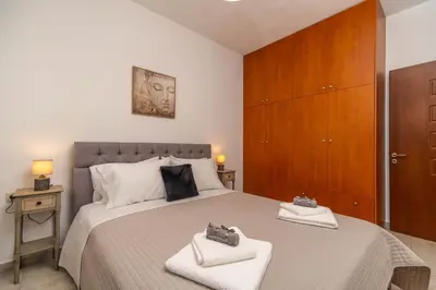 a bedroom with a large bed with two towels at Ampelos in Perivólia