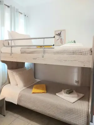 two bunk beds with towels on the bottom bunk at Ampelos in Perivólia