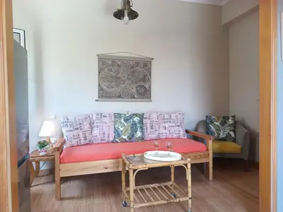 a living room with a couch and a table at Banana Leaves Flat in Chania Town
