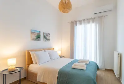 a bedroom with a bed with two towels on it at Corso Venezia Luxury Apartment 3BR in Chania Town