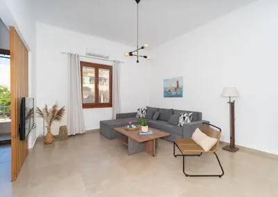 a living room with a couch and a table at Corso Venezia Luxury Apartment 3BR in Chania Town