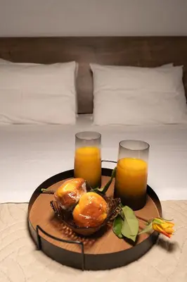 a tray of food and two glasses of orange juice at Corso Venezia Luxury Apartment 3BR in Chania Town