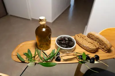 a wooden cutting board with a bottle of oil and bread at Corso Venezia Luxury Apartment 3BR in Chania Town
