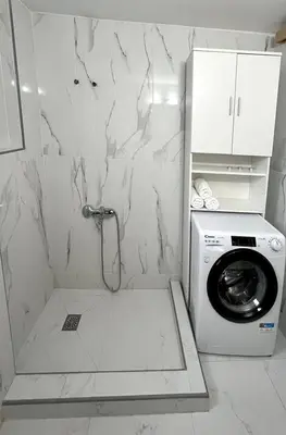 a bathroom with a washing machine and a washer at Yasemi Chania Residences in Chania Town